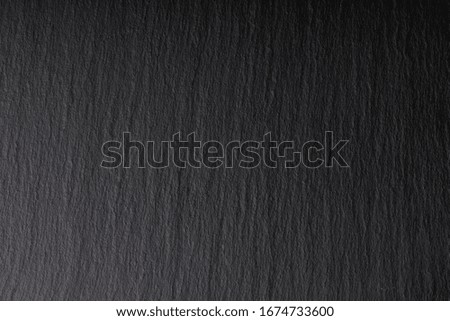 Dark grey slate background or texture.  Natural dark slate board for texture .Wall black background blank for design