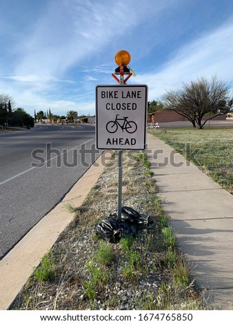 Bike Lane Closed Ahead sign near street in desert