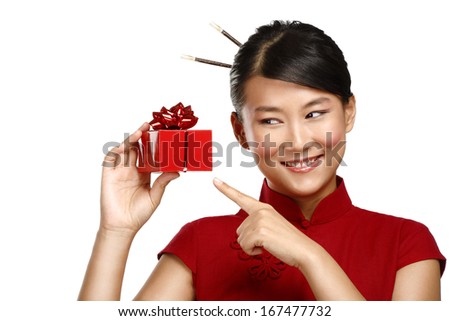 Traditional asian girl showing a christmas gift  on white