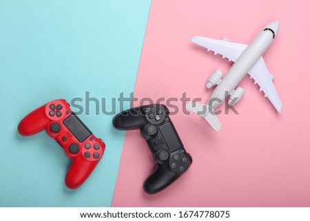 Air game. Gamepads, airplane on a blue-pink pastel background. Top view