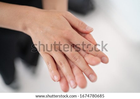Hand sanitizer Corona virus COVID-19 prevention alcohol gel rub for hand hygiene prevention. Woman rubbing soap in palms to clean hands. Royalty-Free Stock Photo #1674780685