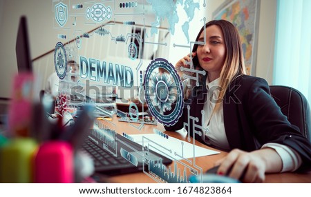 Concept business, technology, blockchain, internet and future network concept of computers. A young girl is working with a neon hologram screen. On screen of the hologram  inscription: DEMAND