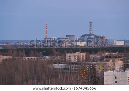 Abandoned ghost town Pripyat, post apocalyptic city, view of nuclear power plant, winter season in Chernobyl exclusion zone, Ukraine Royalty-Free Stock Photo #1674845656