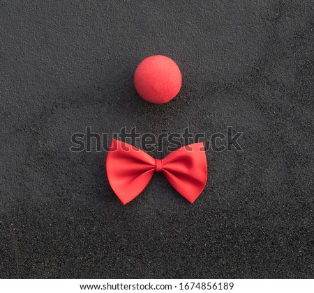 red clown nose on a black background
