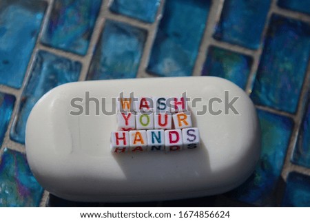 Wash your hands, words spelled out in abc color blocks on bar of soap. Hand washing prevents infection with covid-19, coronavirus, virus and bacteria.