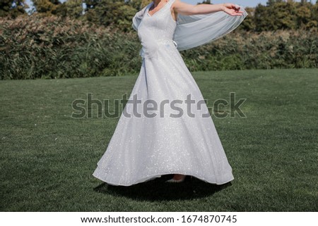 bride in the park alone with green grass