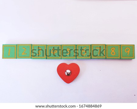 Green wooden blocks written with numbers on white isolated background. 