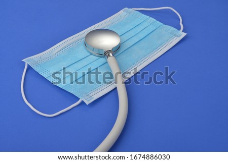 Stethoscope and medical mask on blue background,Concept of medical protection