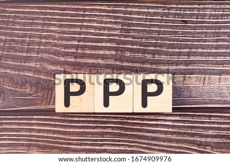 PPP, business concept, the letters are composed of wooden cubes.