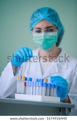 A nurse works in a laboratory with test tubes