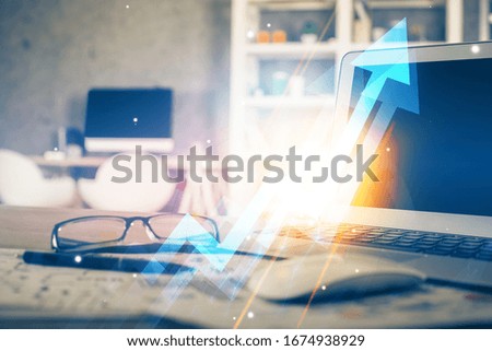Computer on desktop with point up arrows hologram. Double exposure. Concept of success.