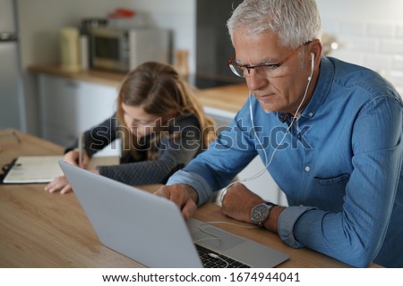 Father and school-girl working form home, telework and e-learning Royalty-Free Stock Photo #1674944041
