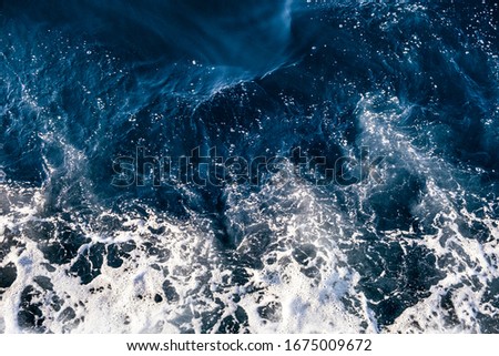Top down aerial view of sea water surface. White foam waves texture as natural background. Royalty-Free Stock Photo #1675009672