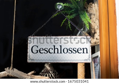 Closed sign in a shop door, german