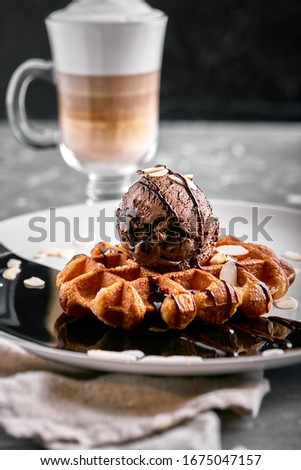 Viennese Waffles with ice cream and coffee. Beautiful picture of dessert with latte coffee. Dessert concept, sweet life. Food photo, copy space, gray background.