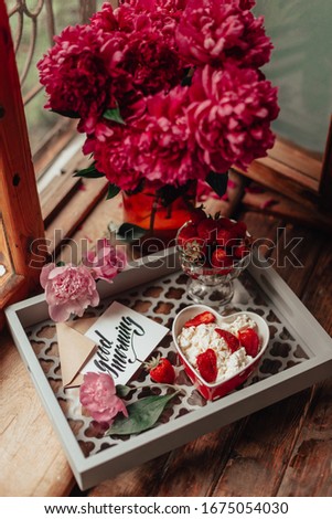Healthy food. Strawberry with cheese. cottage cheese. Flowers on the woodenwindow. Morning. Bon Appetite. Good morning