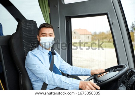 transport, travel and pandemic concept - male driver wearing protective medical mask for protection from virus disease driving intercity bus Royalty-Free Stock Photo #1675058335