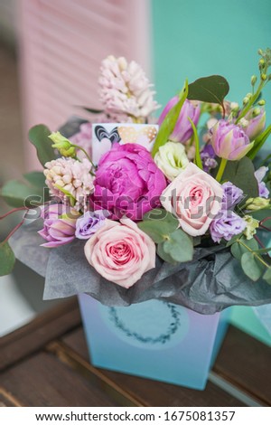 Flowers composition. Wedding bouquet of flowers. Flowers gift. Roses. Purple flowers in the box. 
Valentine's Day