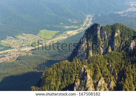 Rocky ridge and upper view of Prahova Valley at the base of Bucegi Mountains, Romania.
