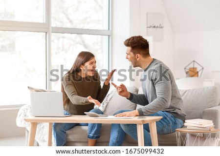 Young couple quarreling at home Royalty-Free Stock Photo #1675099432