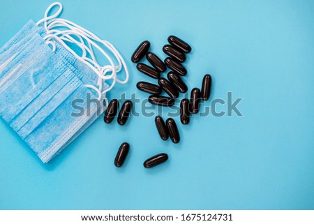blue mask and pills on blue background