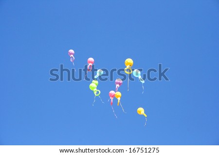 Colorful balloons flying in the blue sky.