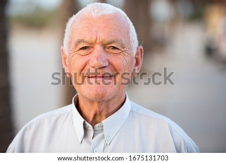 Portrait of positive mature man in the park on holiday Royalty-Free Stock Photo #1675131703