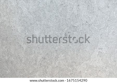Marbled pattern of a smooth light gray stone slab in closeup Royalty-Free Stock Photo #1675154290