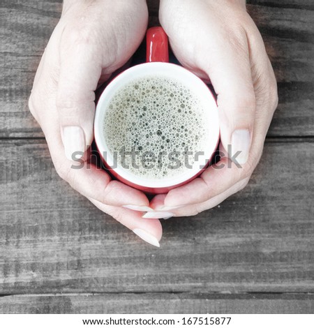 Woman holding hot cup of coffee
