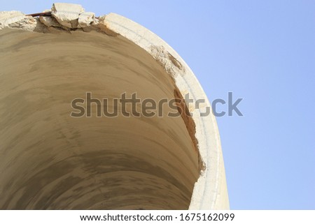 A picture taken on a sunny day of the construction site of an apartment building.