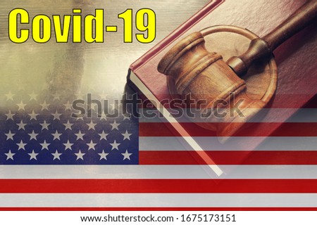 Laws against coronavirus covid-19 in USA concept. Judge gavel on legal book and US flag with text covid-19.