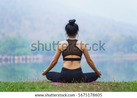 Woman do yoga relax at the outdoors nature background.