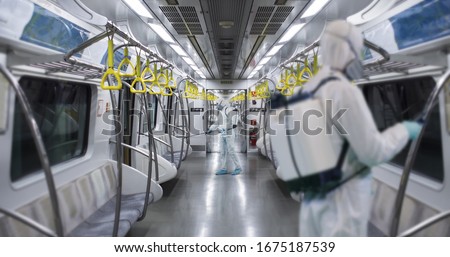 HazMat team in protective suits decontaminating metro car during virus outbreak. Coronavirus COVID-19 Royalty-Free Stock Photo #1675187539