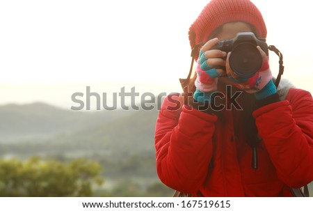 Nature photographer taking pictures during hiking trip