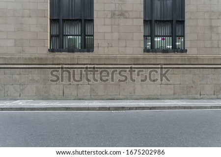 asphalt road and sidewalk with wall of european style architecture . Royalty-Free Stock Photo #1675202986