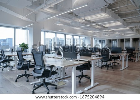 Interior of modern empty office building.Open ceiling design. Royalty-Free Stock Photo #1675204894