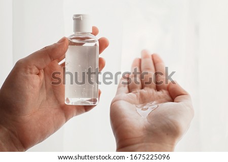 Hands disinfection. Hands with disinfecting alcohol gel and sanitizer bottle, prevent virus epidemic. Prevention of flu disease and coronavirus. Cleaning and disinfecting hands in proper way. Royalty-Free Stock Photo #1675225096