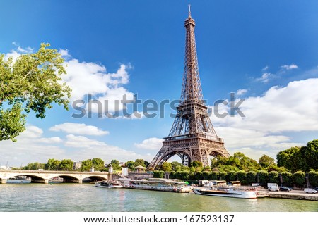 Eiffel tower view, Paris, France. Scenic panorama of Seine River and blue sky. Nice scenery of Eiffel tower and tourist boats, beautiful city landscape, Paris skyline in summer. Tourism, travel theme Royalty-Free Stock Photo #167523137