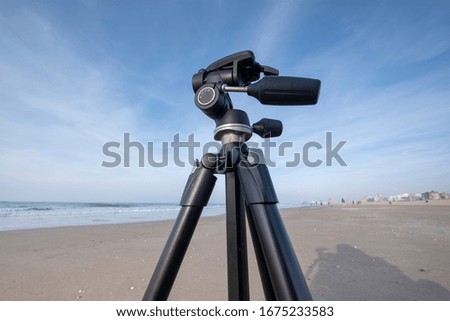 A part of a tripod on a yellow sand beach, on the background blue Sea and sky, Scheveningen, The Hetherlands
