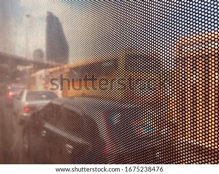 Traffic and public transport in Thailand Looking through the dusty glass of the bus and the circular pattern that causes eye strain.
