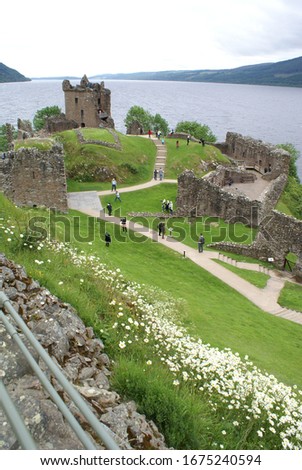 Panoramic view of the ruins of Urquhart Castle, with Loch Ness lake in the background