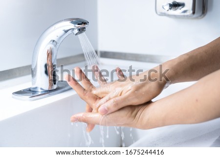 Man hands washing by sanitizer, soap with water for prevention corona virus, bacteria and germ, health care concept.