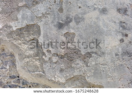 Destroyed chipped wall of cellar farm house. Light exterior urban facade. Whitewashed ruined structure background. Grunge uneven old stone rock texture. Outside crack crash cement mortar for 3d design