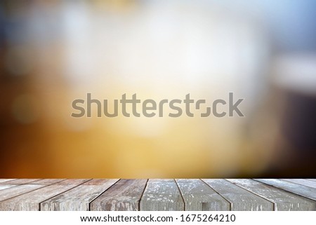 Old Grunge Wooden Table with Blurred Cafe Background, Suitable Product Presentation and Backdrop.
