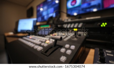 Blur view of professional video switcher buttons and broadcast room. Not in focus Royalty-Free Stock Photo #1675304074