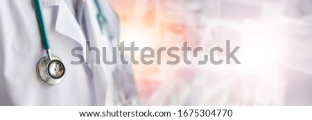 Medical doctor or physician in white gown uniform with stethoscope in hospital or clinic fighting with COVID-19 with laboratory background banner Royalty-Free Stock Photo #1675304770