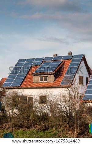 House with a lot of solar panels on the roof Royalty-Free Stock Photo #1675314469