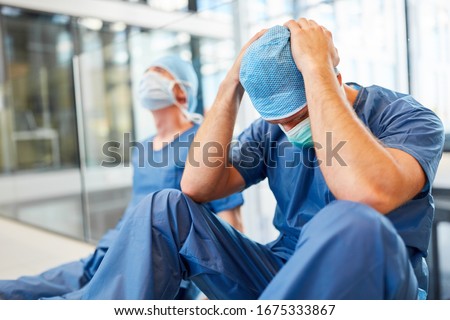 Two exhausted and desperate surgeons as signs of congestion and error Royalty-Free Stock Photo #1675333867