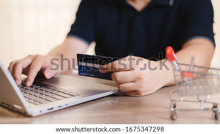 Online shopping on laptop, making payment by credit card
