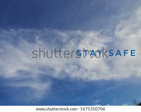 blurry bqckground of white clouds with text stay safe Royalty-Free Stock Photo #1675350706